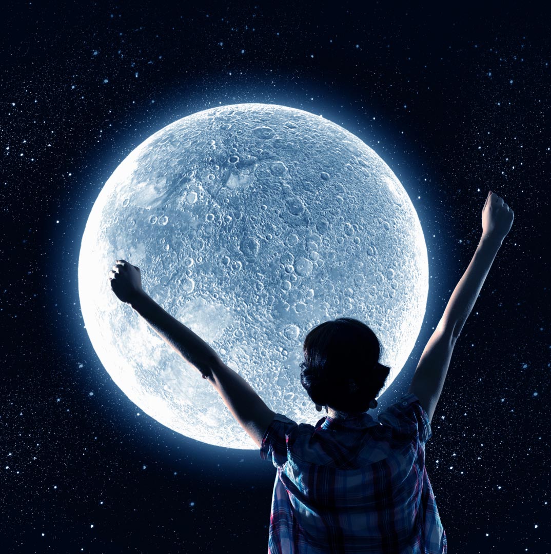 A big full moon with a woman raising her hands towards it